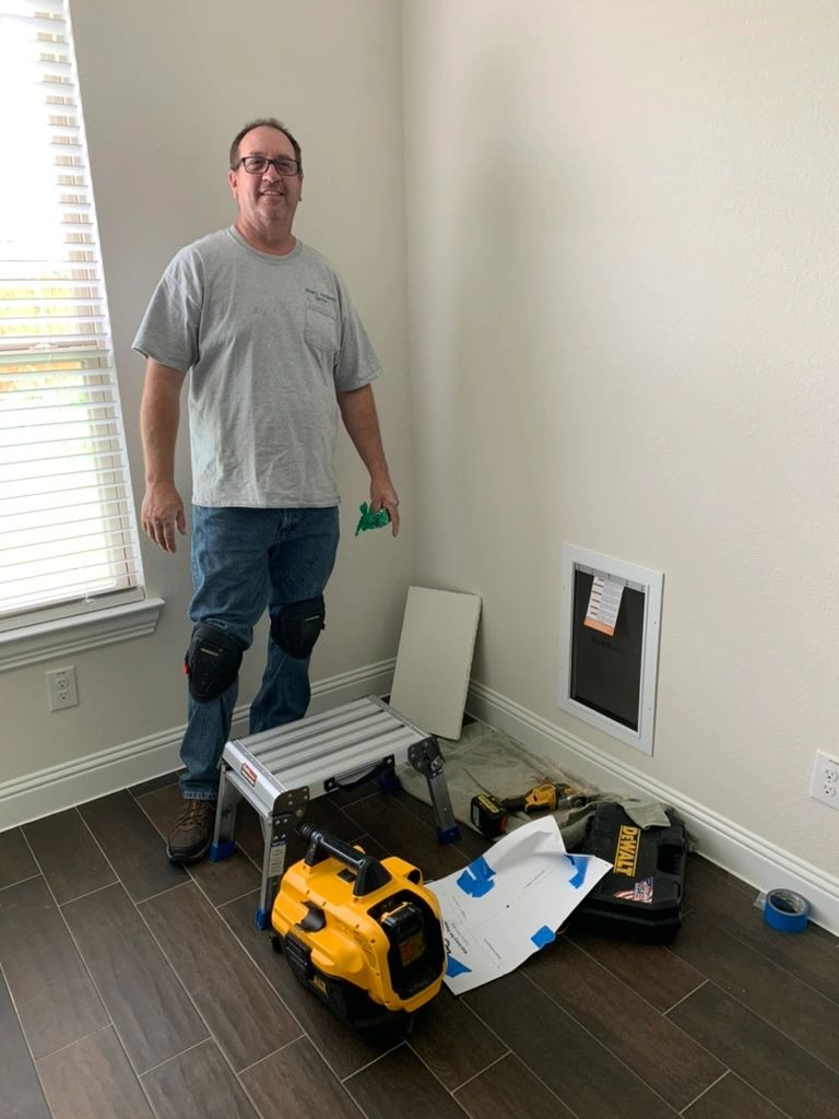 Professional pet door installer at work